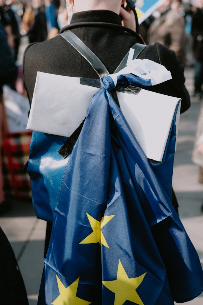Close-up of a protester with an EU flag in a street rally, showcasing activism.